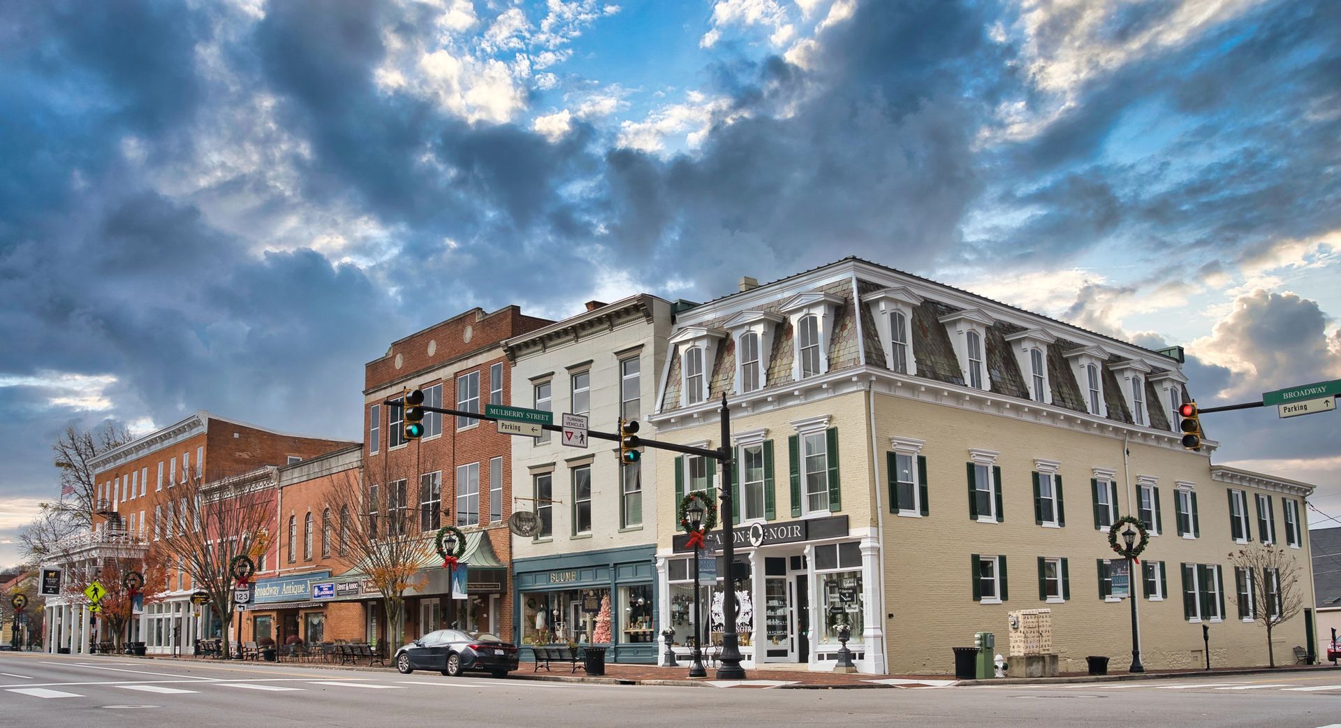A row of buildings on the corner of a city street.