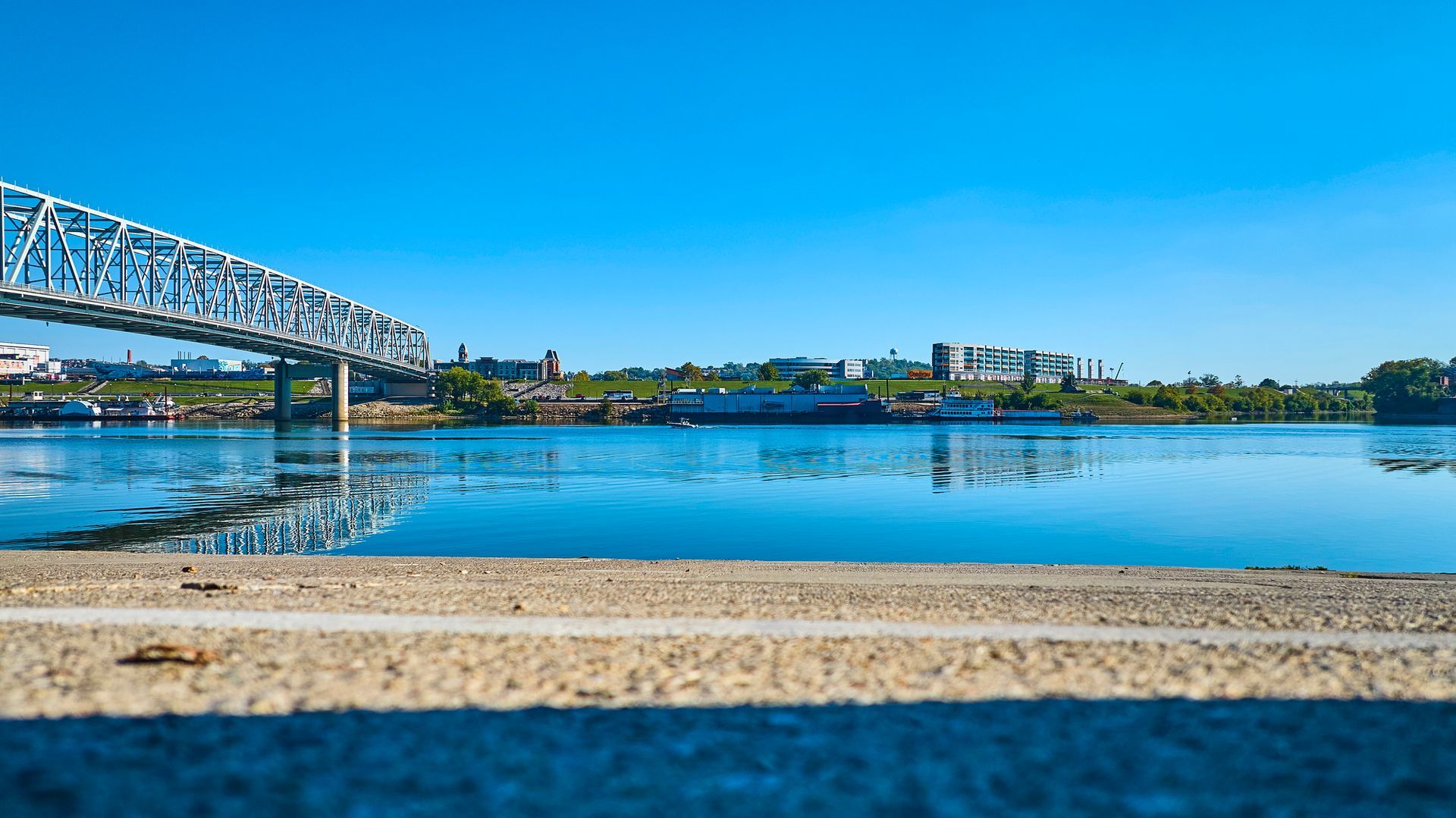 A bridge over a body of water with a city in the background.