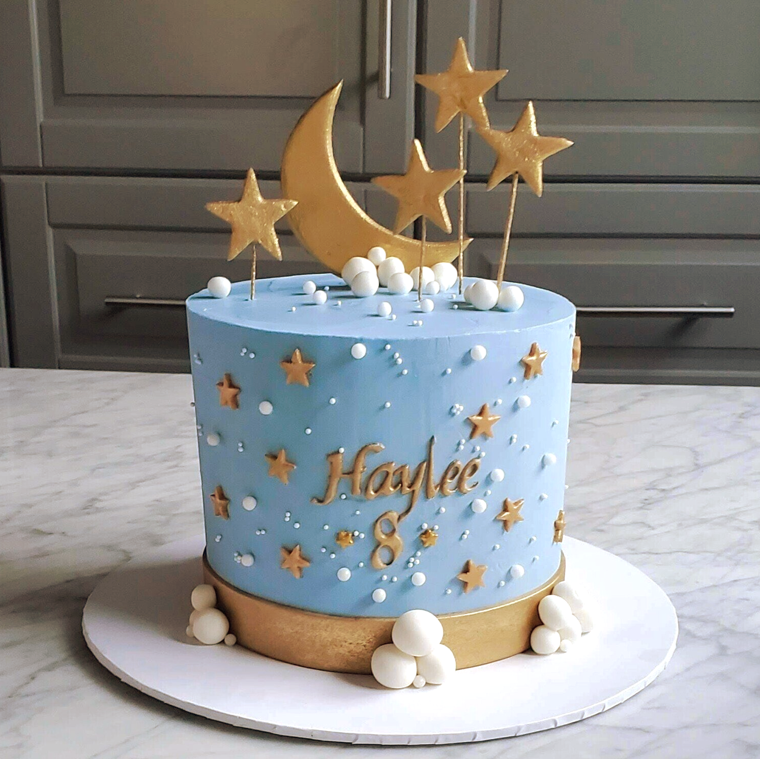 blue cake with moon and star decorations