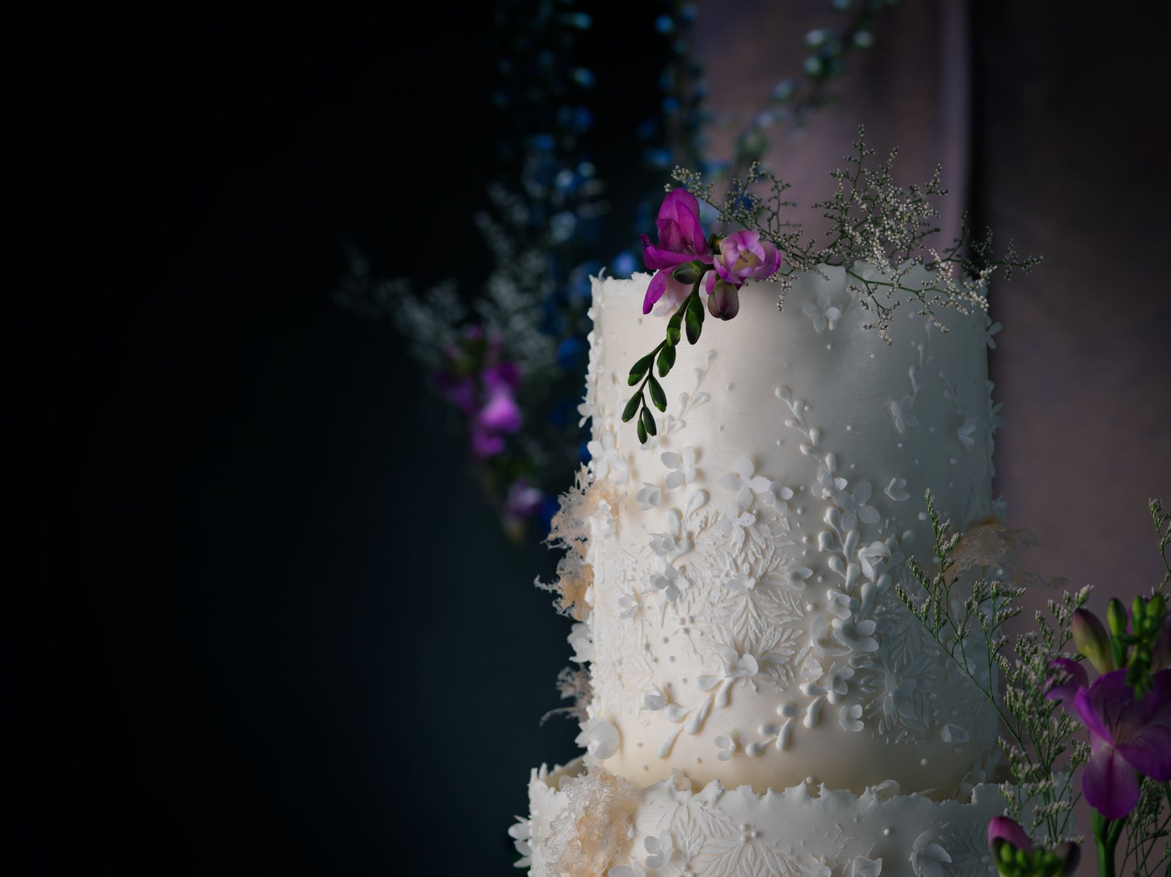white cake with pearls and florals