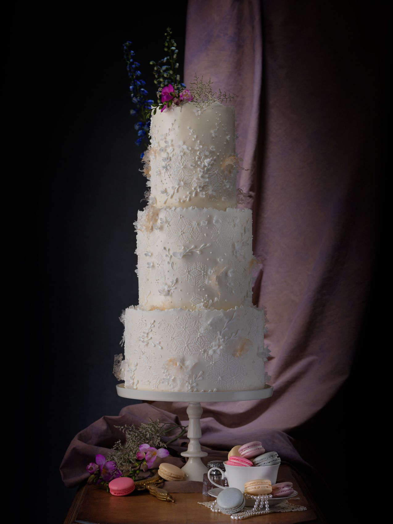 three tier cake with pearls and textures