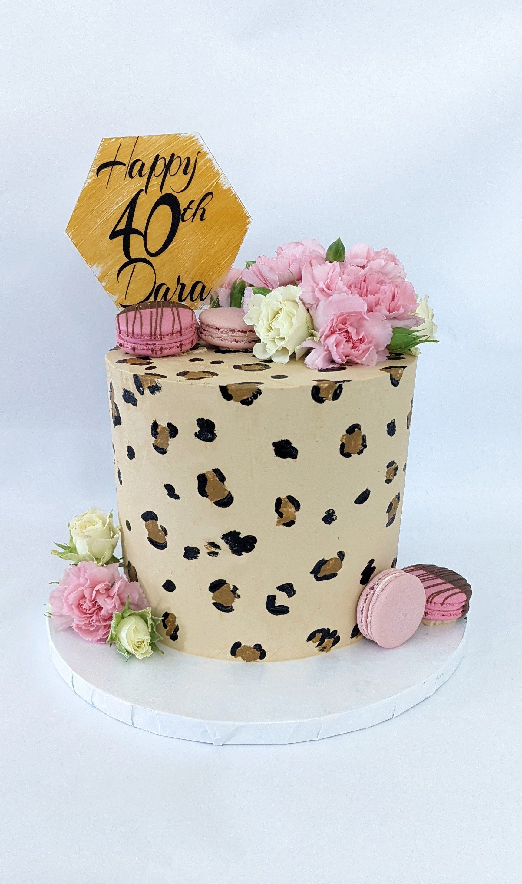 cheetah pattern cake with macarons and florals