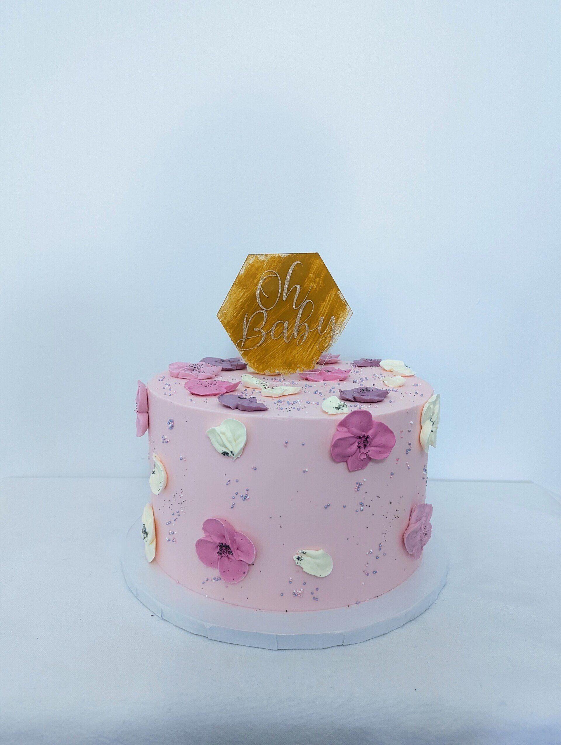 pink cake with flowers and topper