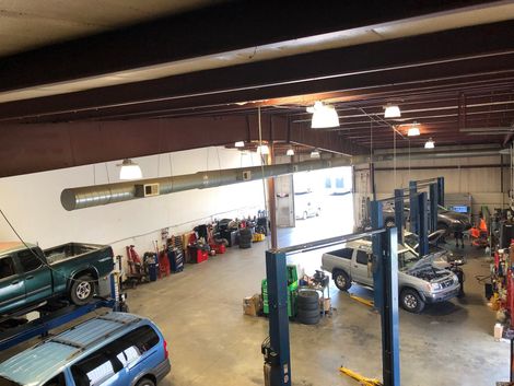 An Aerial View of a Garage with Car on Lifts | Concord Auto Service Center