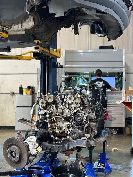 A Mechanic is Working on a Car Engine | Concord Auto Service Centera car engine in a garage.