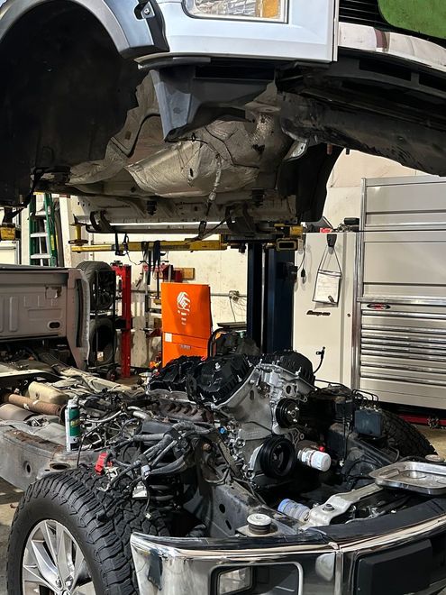 A Car is Being Repaired in a Garage with the Hood Open | Concord Auto Service Center