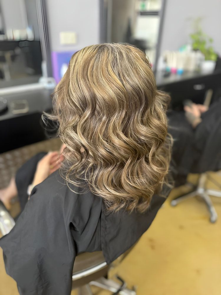 A Woman is Sitting in a Chair With Her Hair in a Salon —  L'Auranda Hair Salon In  Evan St. Mackay, QLD
