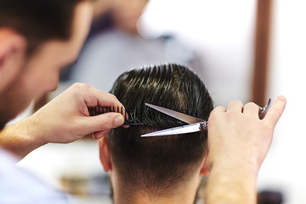 A Man Is Getting His Hair Cut By A Barber — L'Auranda Hair Salon In Evan St. Mackay, QLD