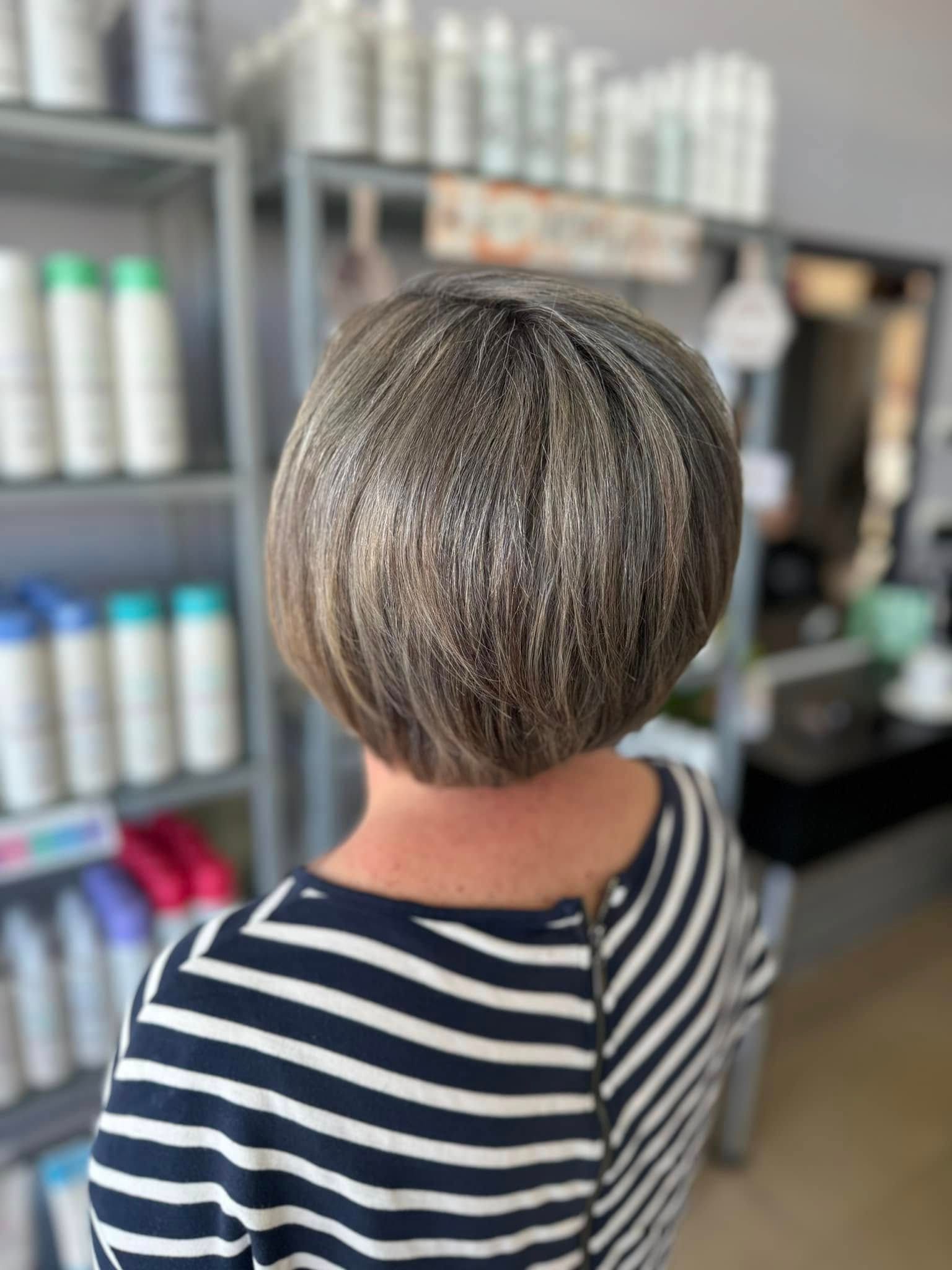 A Woman Is Getting Her Hair Done By A Hairdresser —  L'Auranda Hair Salon In  Evan St. Mackay, QLD
