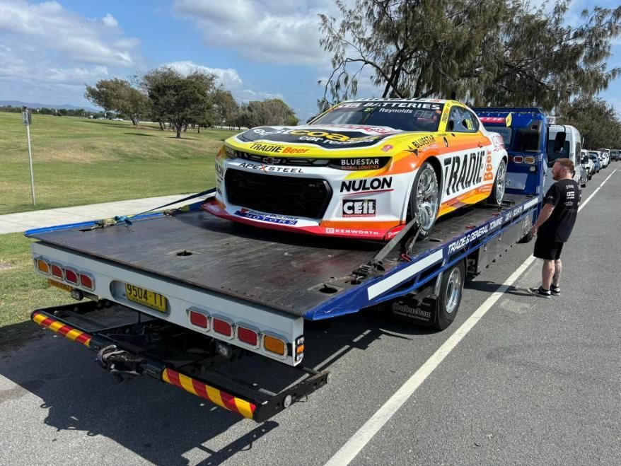 A Race Car is Being Towed by a Tow Truck — Trade & General Towing in Sandgate, NSW