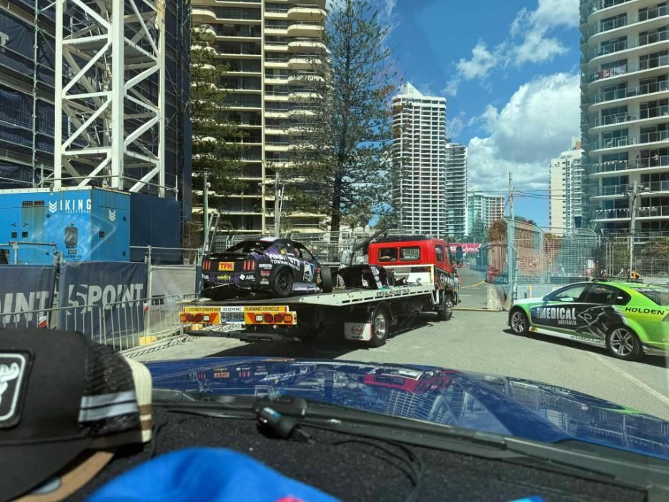 A Car is Being Towed by a Tow Truck in a City — Trade & General Towing in Lake Macquarie, NSW