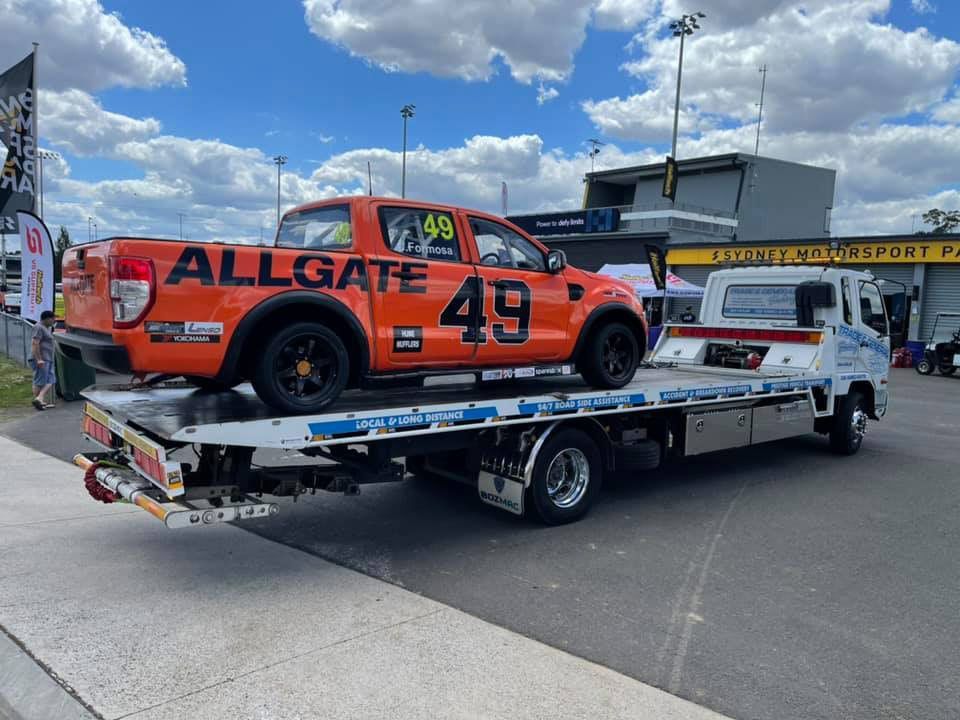 Allgate 49 Orange Pick Up — Trade & General Towing in Charlestown, NSW