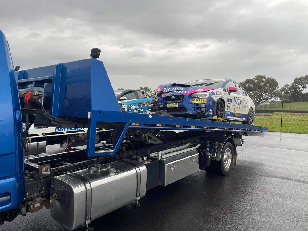 Blue Towing Truck Towed the Subaru WRX Sport Car — Trade & General Towing in Maitland, NSW