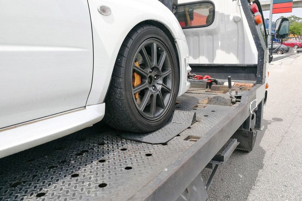 Broken Down Auto Vehicle Towed Onto Flatbed Tow Truck — Trade & General Towing in Sandgate, NSW