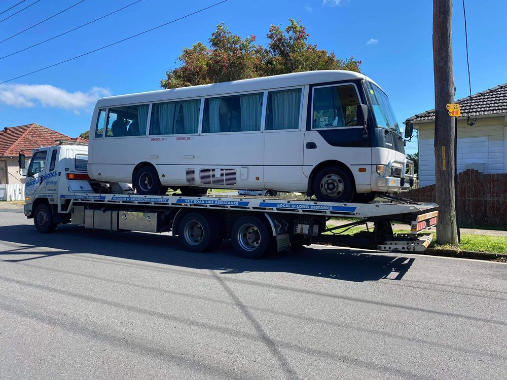 Bus Loading On The Towing Truck — Trade & General Towing in Cardiff, NSW