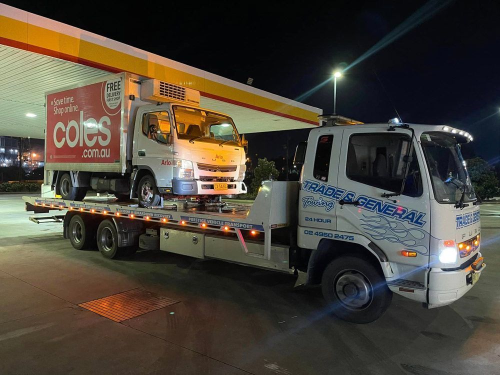 Closed Container Truck Towed at the Gasoline Station— Trade & General Towing in Sandgate, NSW