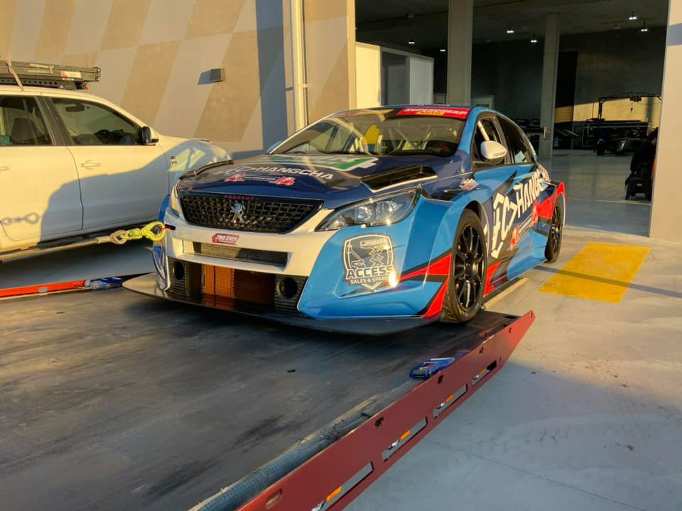 A Blue Race Car is Sitting on Top of a Tow Truck — Trade & General Towing in Cardiff, NSW