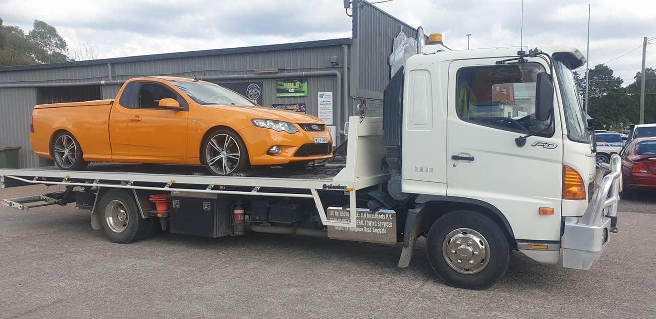 Towing Ford Falcon UTE — Trade & General Towing in Belmont, NSW