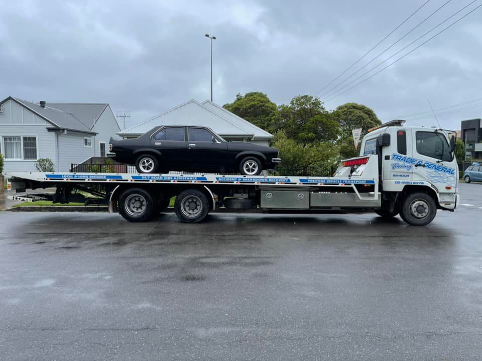 Towing the Black Car — Trade & General Towing in Sandgate, NSW