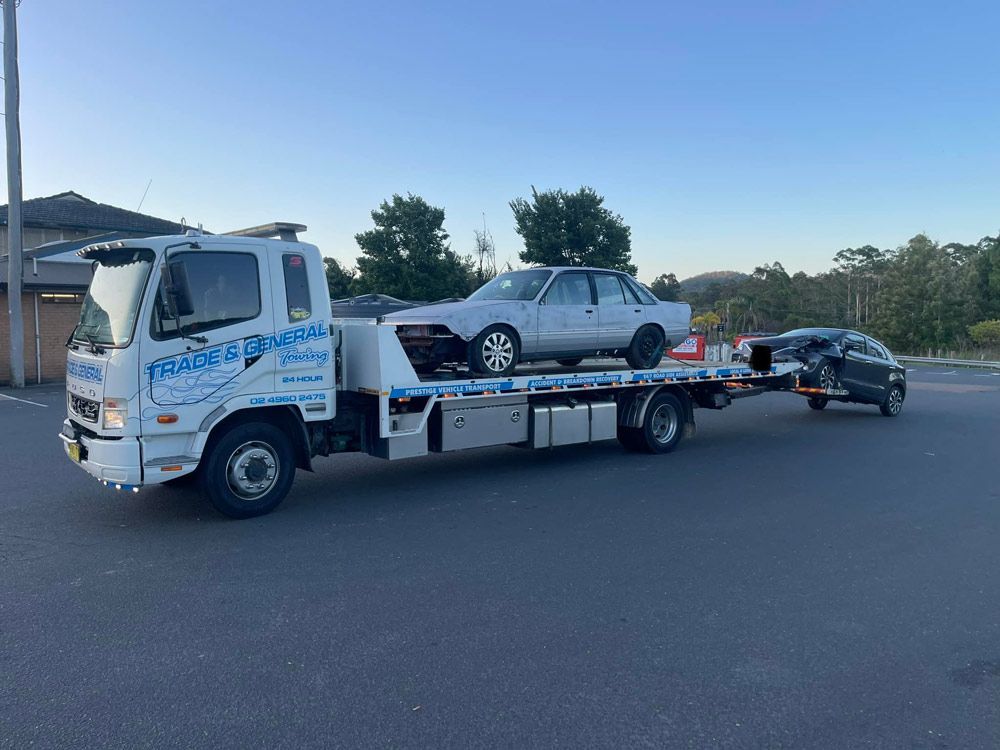 Two Accident Car Being Towed — Trade & General Towing in Wallsend, NSW