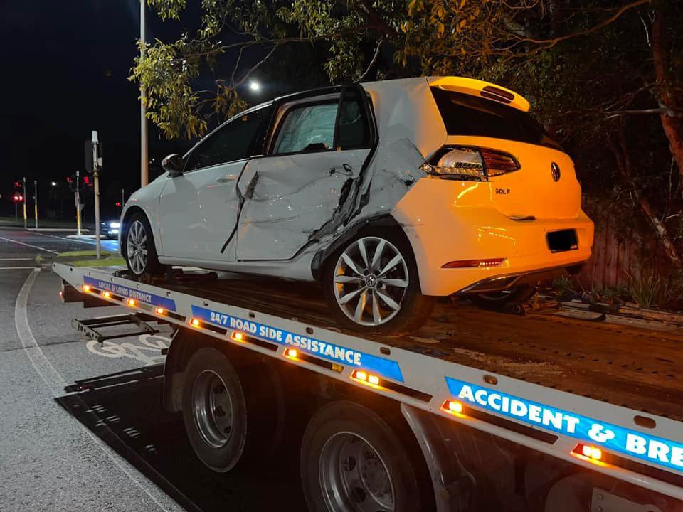 A White Car is Sitting on Top of a Tow Truck — Trade & General Towing in Cessnock, NSW