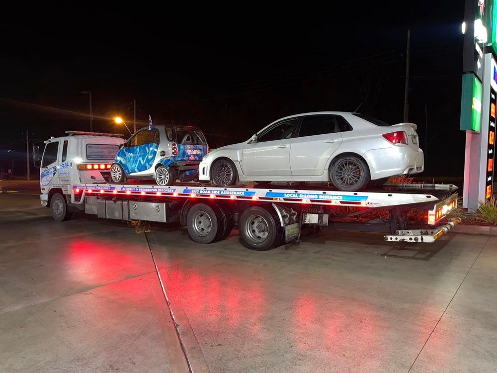 White Car and Compact Car Towed at Nights — Trade & General Towing in Warners Bay, NSW
