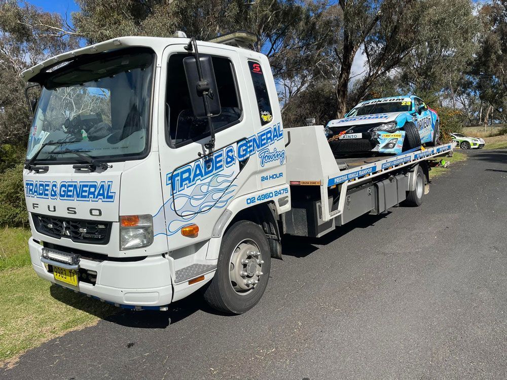 White Trade and General Towing Truck Tow the Broken Racing Car — Trade & General Towing in Sandgate, NSW