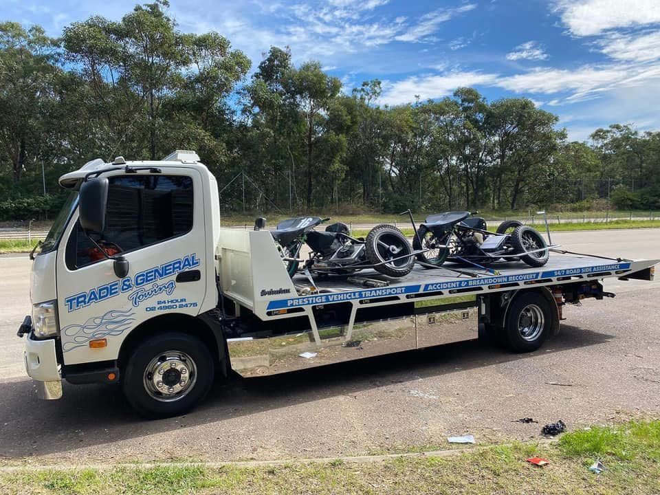 White Truck Towed the Two Motocycle Side on the Highway — Trade & General Towing in Sandgate, NSW