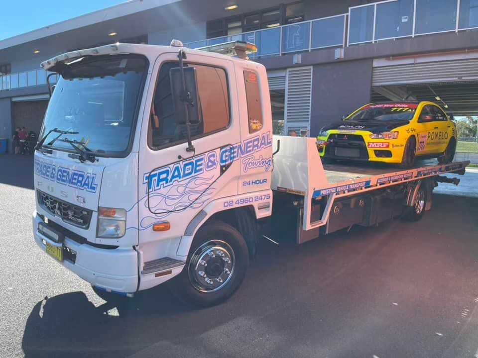 Yellow Pomelo Racing Car Towing — Trade & General Towing in Sandgate, NSW