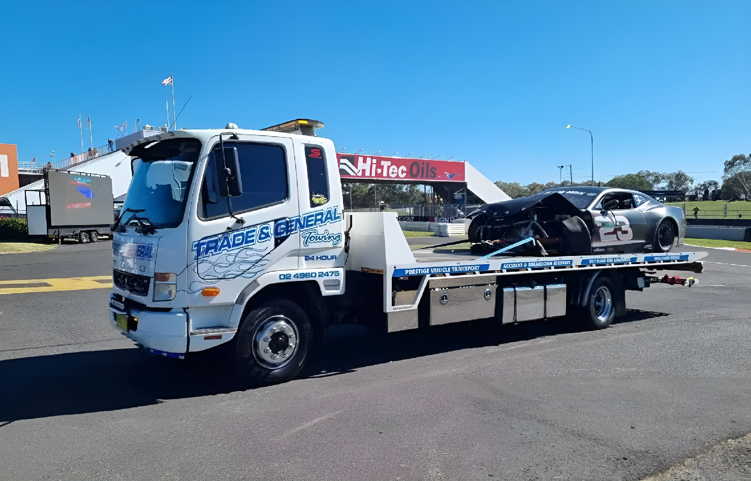Tow Truck Removing Damaged Car From Roadside Emergency Scene