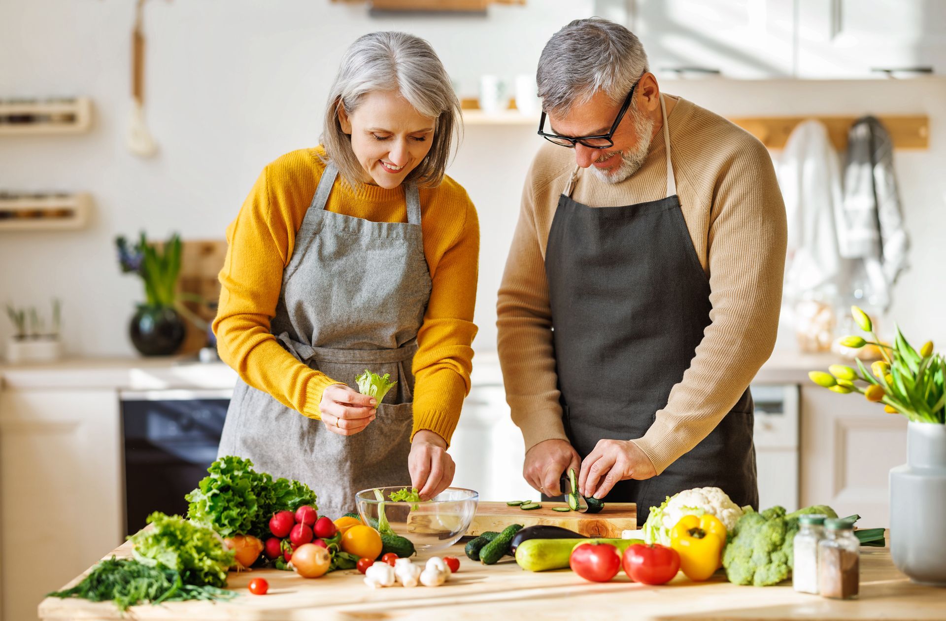 Happy Elderly Couple Preparing Salad