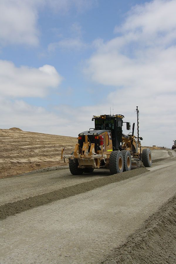 A bulldozer is driving down a dirt road
