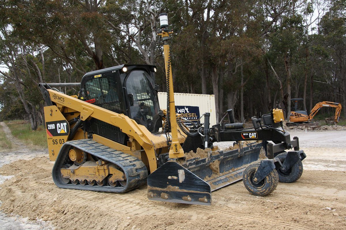 A row of construction vehicles are parked next to each other on a construction site.