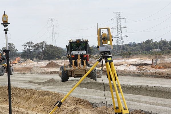 A construction site with a bulldozer in the background