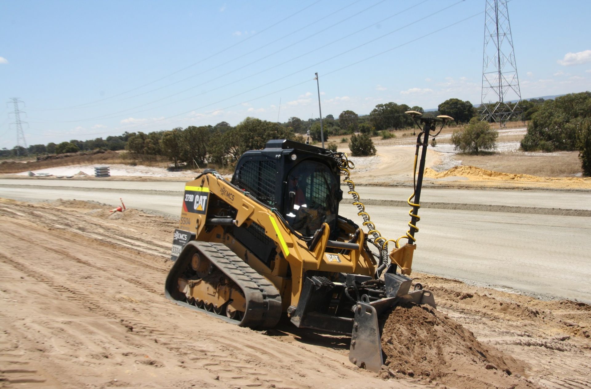 A bulldozer is driving down a dirt road.
