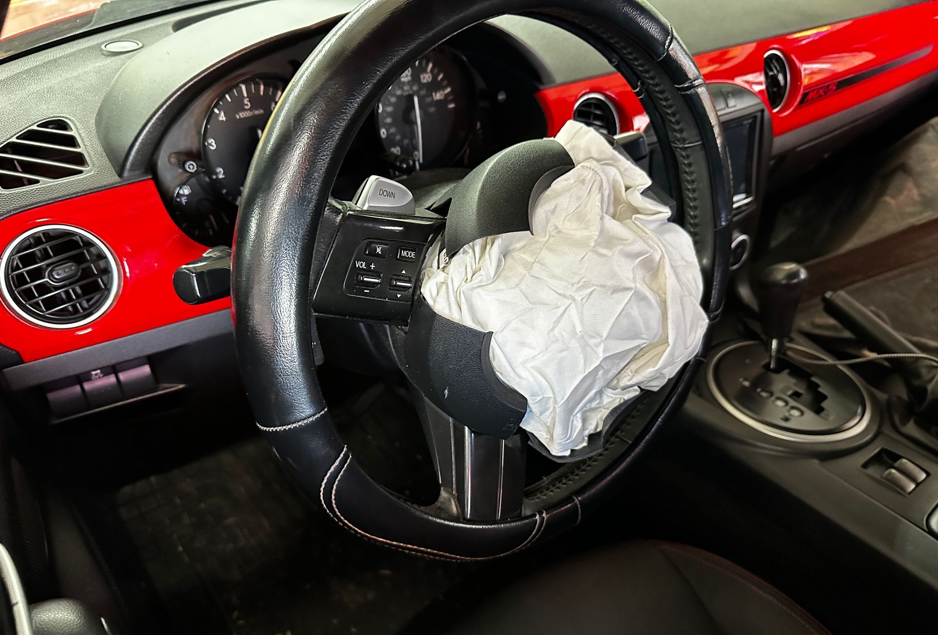Pre‑repair photo showing airbag deployment from collision