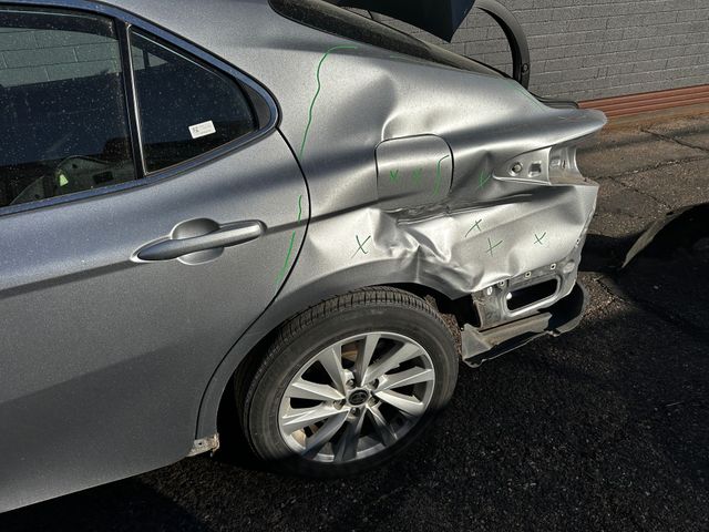 Back of vehicle showing dented bumper and body damage