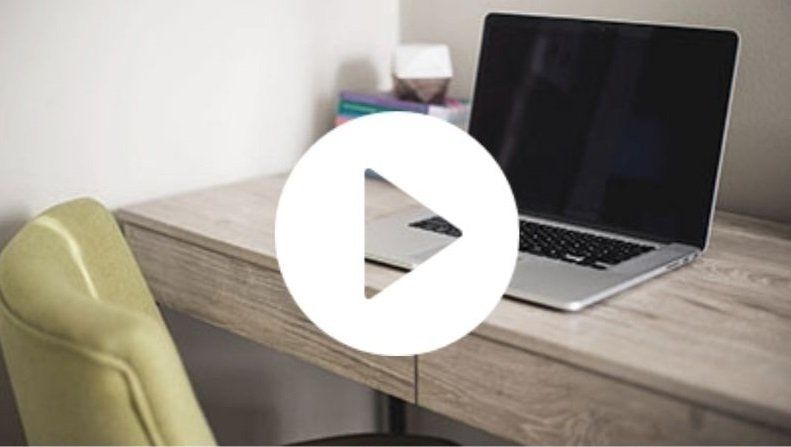 a laptop computer is sitting on a wooden desk .