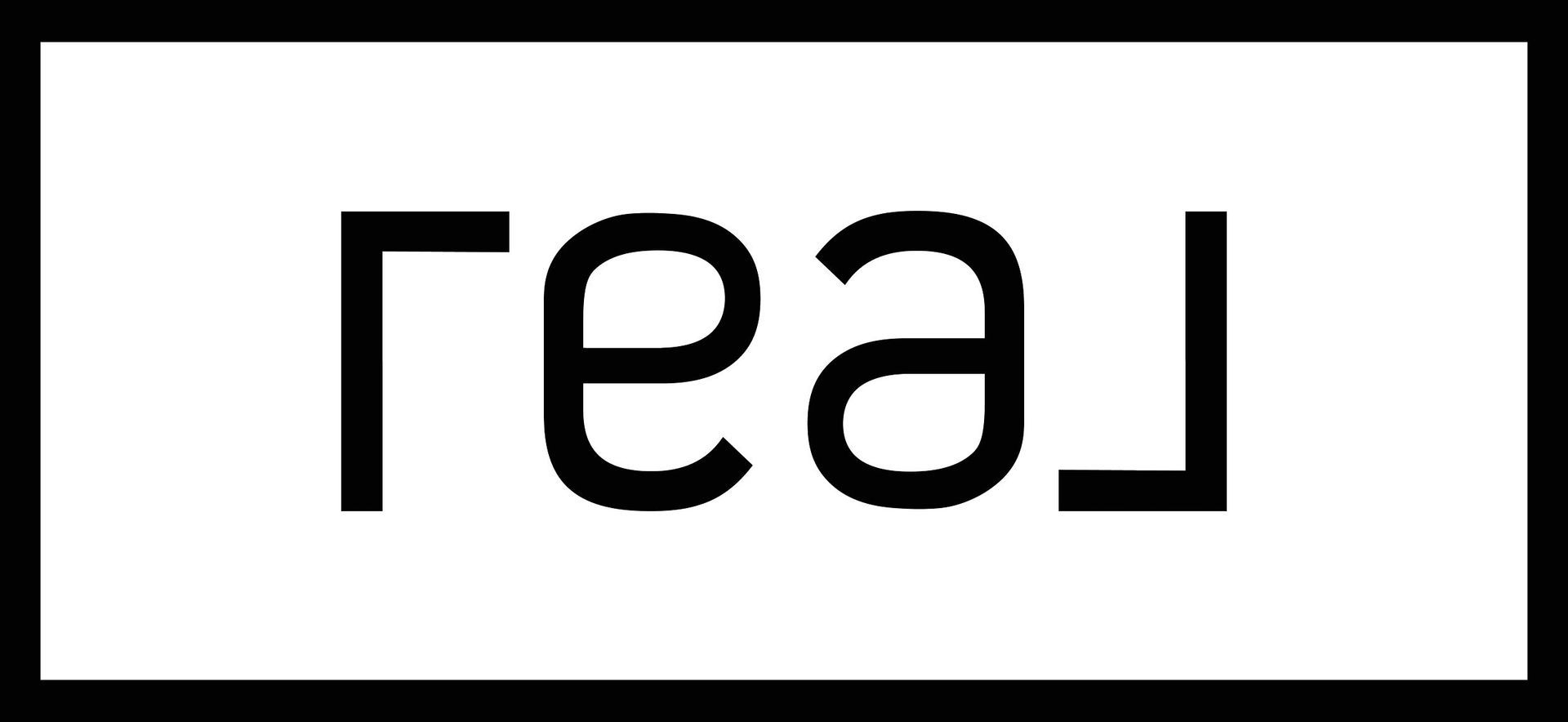 Black mirrored text reading &ldquo;real&rdquo; on a white background