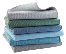 A stack of towels of different colors are stacked on top of each other.