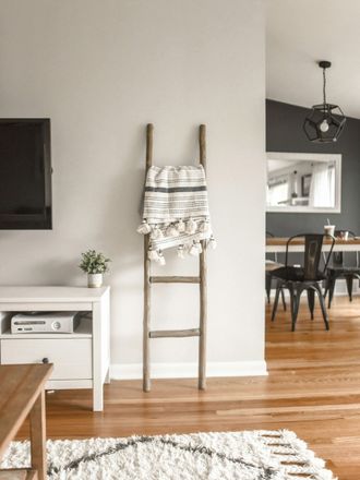 A ladder with a blanket on it in a living room