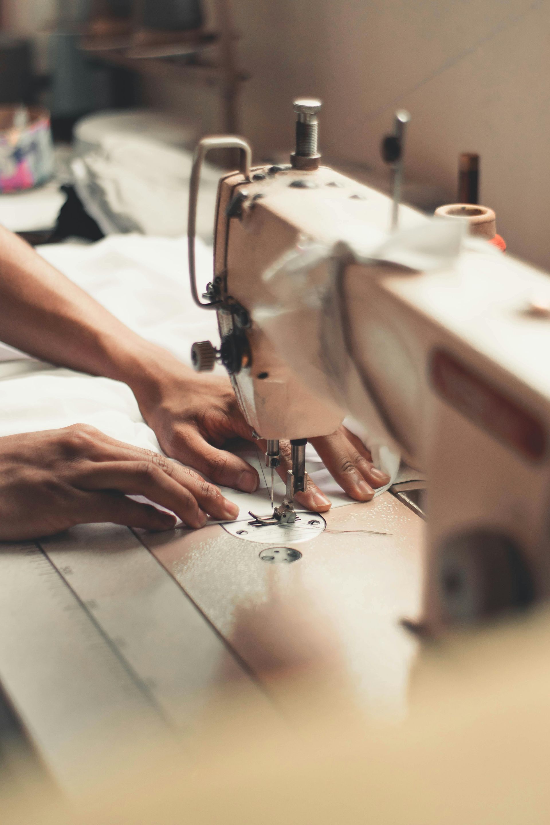A person is using a sewing machine to sew a piece of fabric.