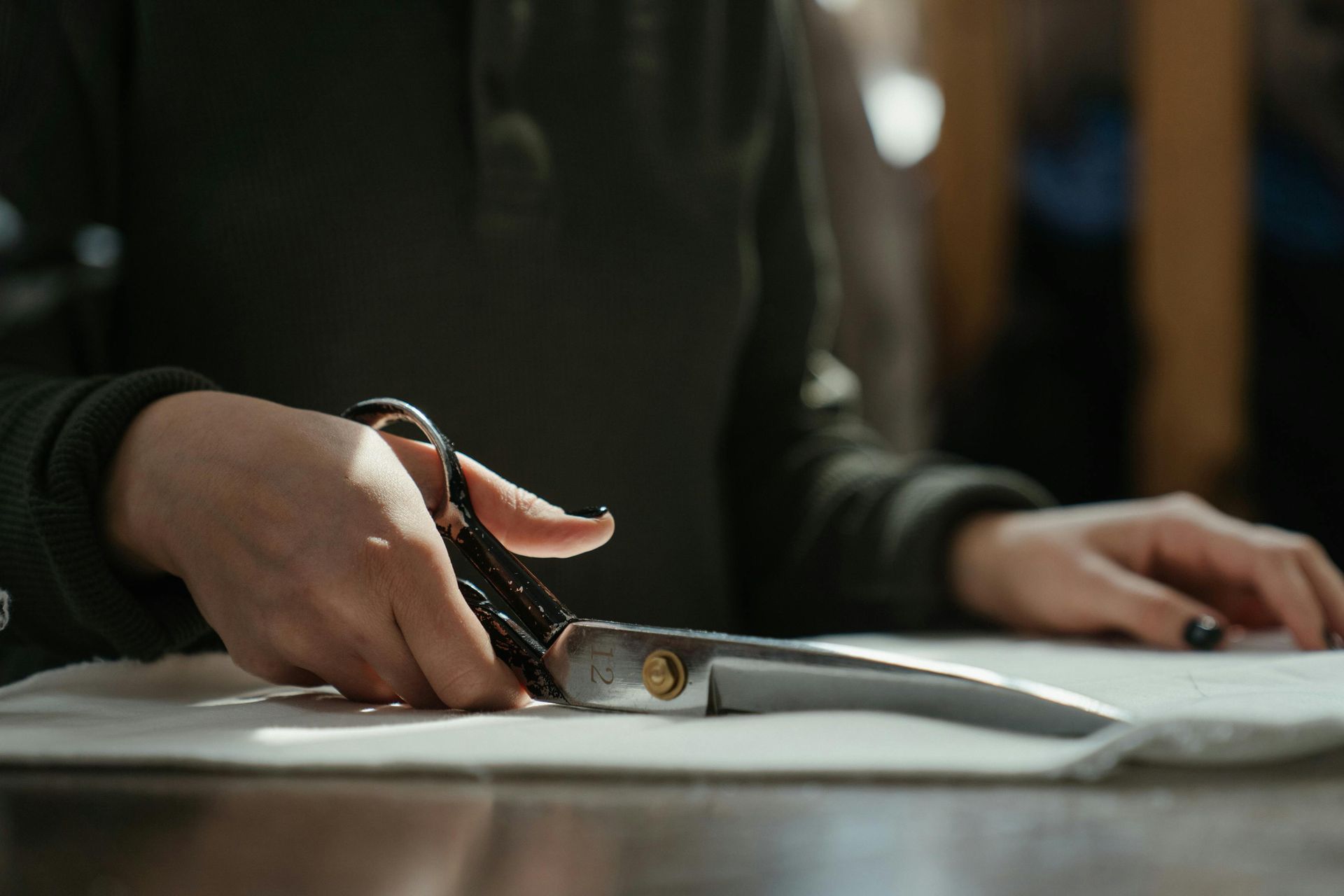 A person is cutting a piece of paper with scissors.