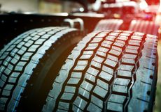 A close up of two tires on the back of a truck.