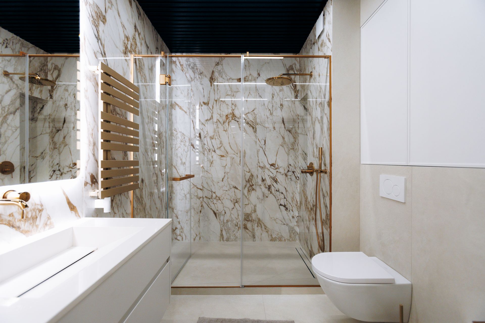 Upscale spa style bathroom with veined stone and metallic accents. Upscale spa style bathroom with veined stone and metallic accents.