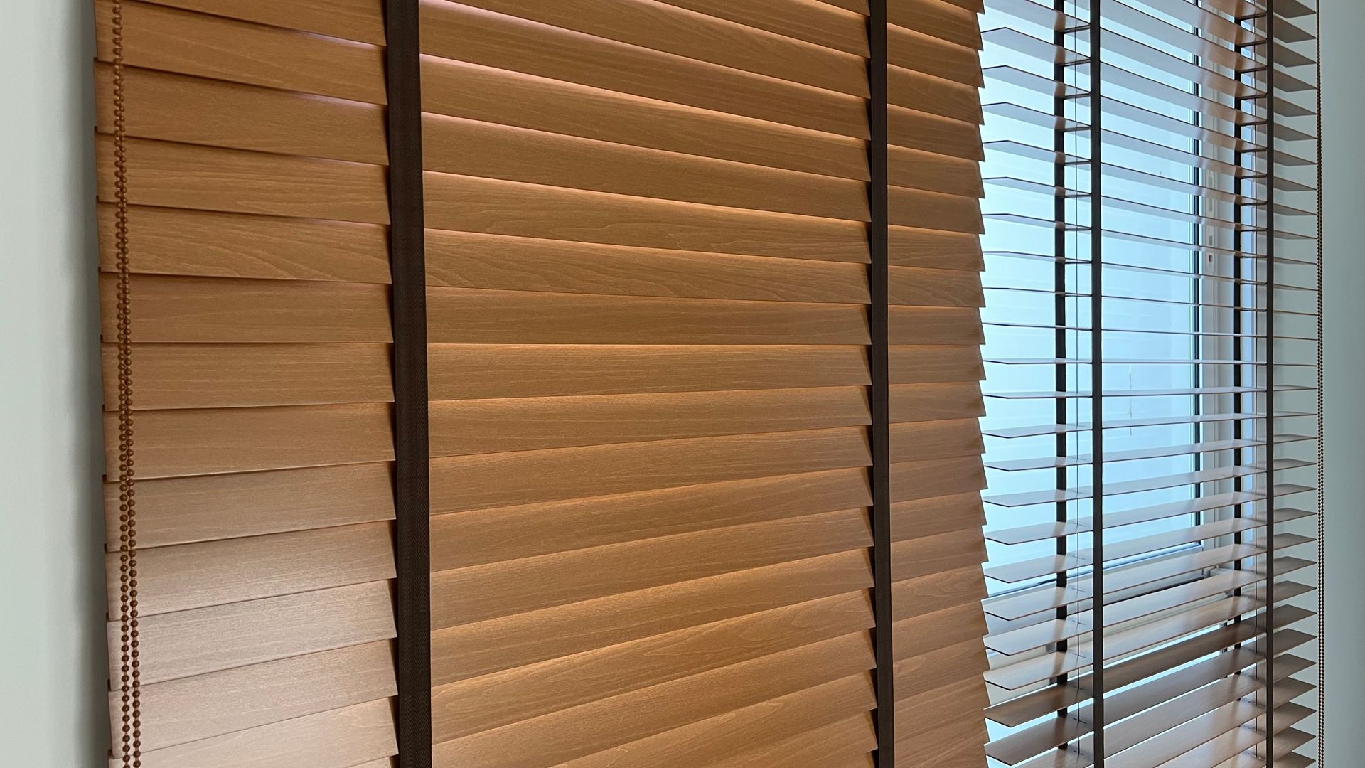 Wooden blinds covering windows for light control and privacy