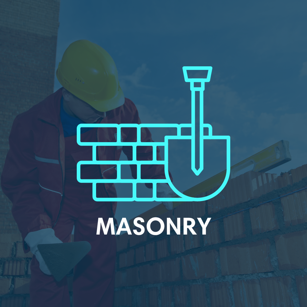 A man wearing a hard hat is working on a brick wall.