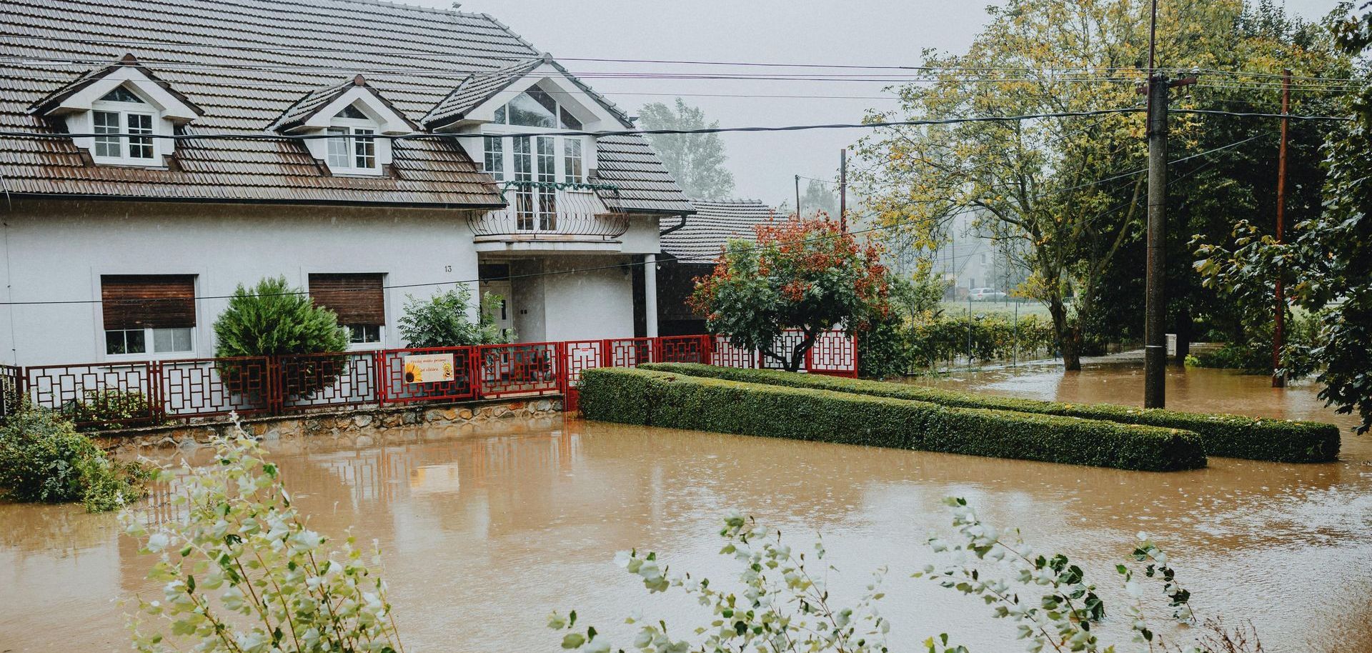 A house is surrounded by a flooded yard.