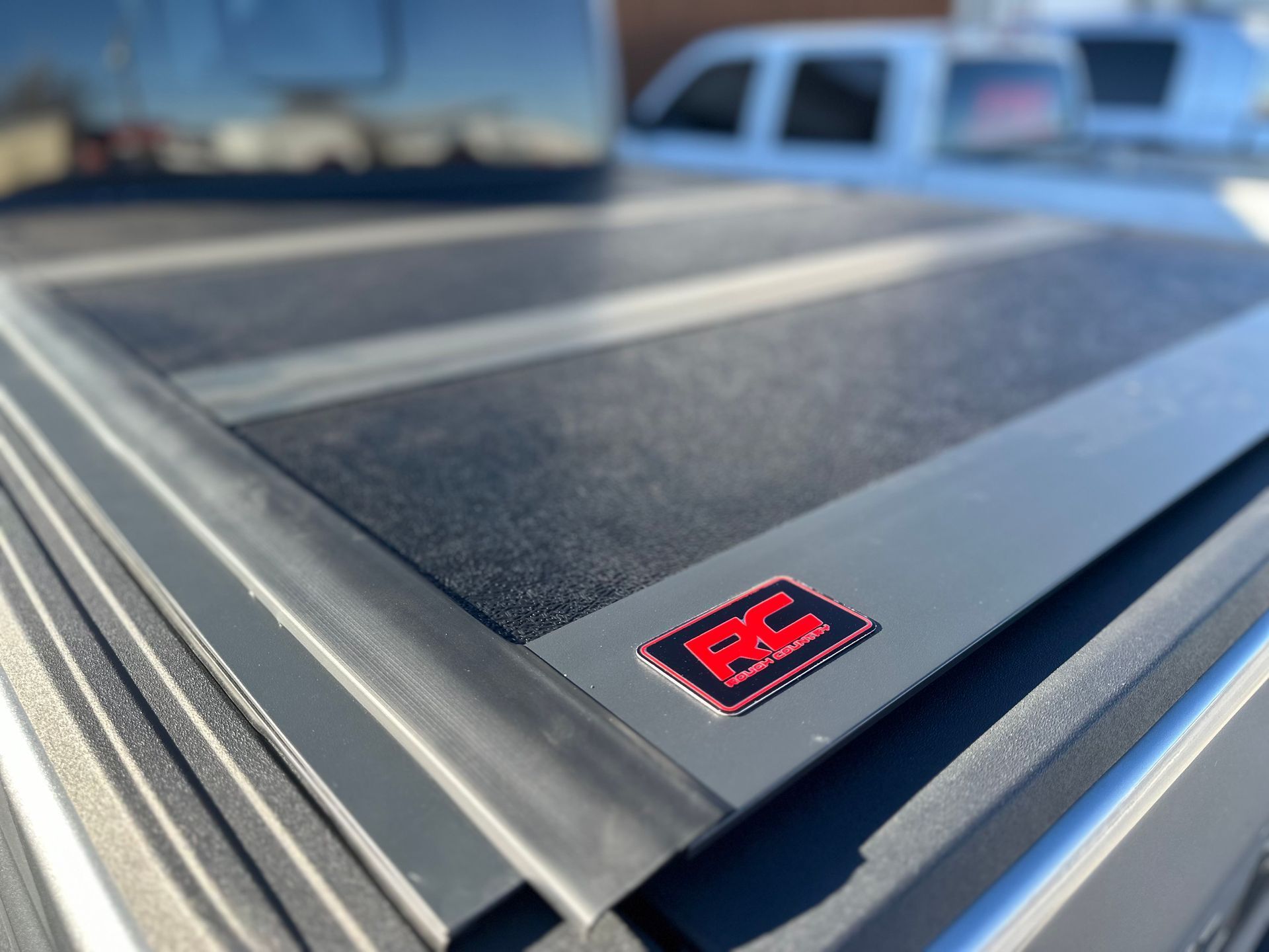 Black truck bed cover with a red and gray 
