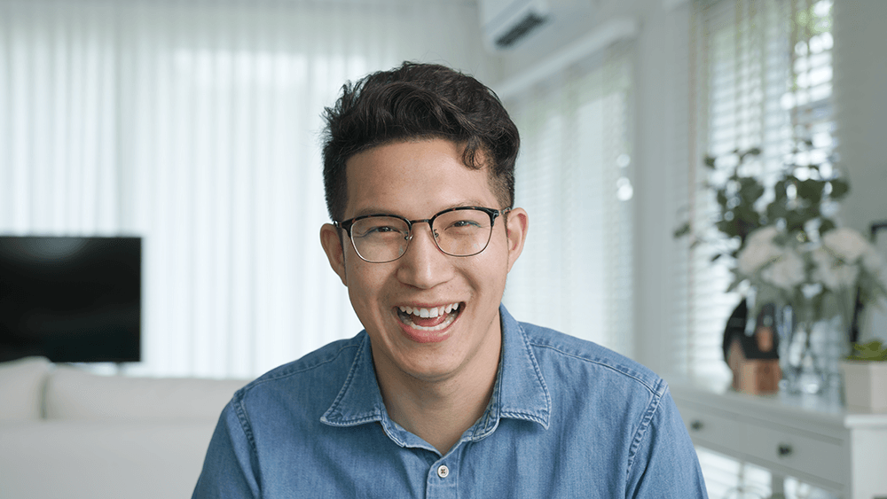 guy smiling laughing while sitting inside
